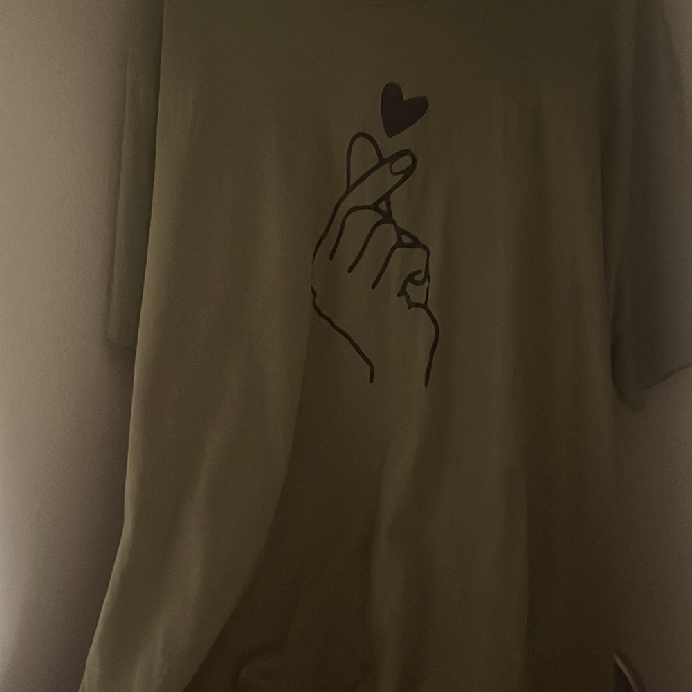 Green Plus t-shirt with a finger heart